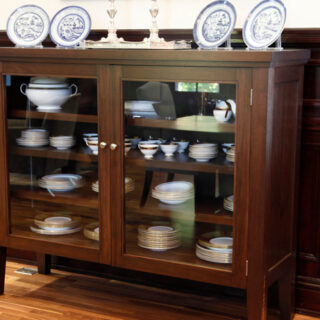 Library cabinet in walnut by Infusion Furniture - shown being used as dinnerware display cabinet
