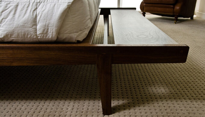 Cantilevered bench extension closeup of Tapered Bed by Infusion Furniture - black walnut